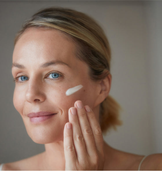 Woman holding a Hanacure brush near her face